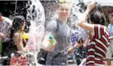  ?? Photo: Apichart Jinakul / Bangkok Post ?? People splash water during the Songkran festivitie­s on Khao San Road in April 2018.