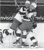  ?? GERRY BROOME/AP ?? Blue Jackets center Jack Roslovic, right, hugs defenseman Seth Jones after Jones’ winning goal in overtime against Carolina on Thursday.