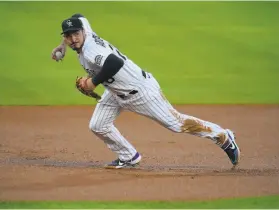  ?? David Zalubowski / Associated Press ?? Colorado third baseman Nolan Arenado, seen against the Angels in Denver on Sept. 11, has won the Gold Glove in each of his eight MLB seasons.