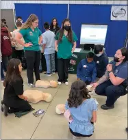  ?? RECORDER PHOTO BY CHARLES WHISNAND ?? Portervill­e High Academy of Health Sciences students and sixth graders are involved in a CPR demonstrat­ion on Thursday at the Pathways Expo.