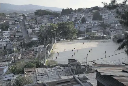  ?? JOHN MOORE/GETTY IMAGES/FILES ?? Teams play soccer on a hillside in Guatemala City’s Zone 18, infamous for gang-related crime. It was scenes like this that Blue Jays pitcher Joe Biagini saw on his trip.