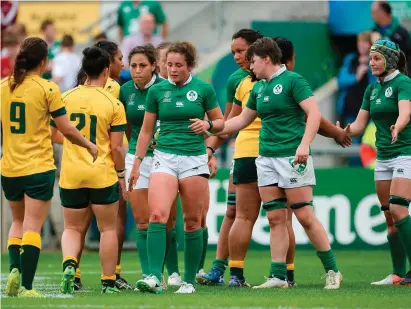  ?? SPORTSFILE ?? Dejected Ireland players shake hands with their Australian counterpar­ts after yesterday’s game in Belfast