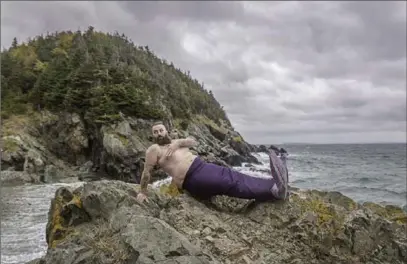  ?? AUBREY DAWE, THE CANADIAN PRESS ?? William Whelan is shown in an handout image at Beach Cove in Portugal Cove, N.L. near St. John’s for the 2018 Merb’ys calendar.