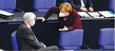  ?? Agence France-presse ?? ↑
Angela Merkel and Interior Minister Horst Seehofer talk during a session at the Bundestag on Thursday.