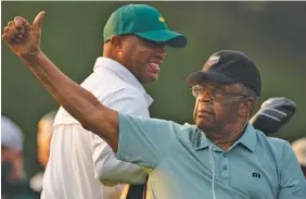  ?? AP PHOTO/CHARLIE RIEDEL ?? Lee Elder, who in 1975 became the first Black golfer to compete in the Masters, gestures as he arrives for the ceremonial tee shots before the first round Thursday in Augusta, Ga.