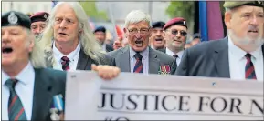  ??  ?? Dennis Hutchings, centre, on a march for veterans in central London. Left, campaignin­g MP Sir Henry Bellingham and, right, Daily Express front page