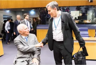  ??  ?? German Finance Minister Wolfgang Schaeuble, left, greets Greek Finance Minister Euclid Tsakalotos during a meeting in Luxembourg on Thursday. (AP)