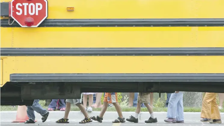  ?? POSTMEDIA/FILE ?? Bill 1 aims to bar school districts from charging for bus transport, but it’s not certain how the legislatio­n will be applied by cash-strapped Edmonton school boards.