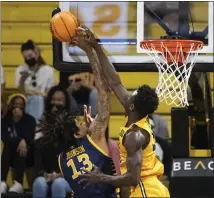  ?? PHOTO BY KYUSUNG GONG ?? Long Beach State forward Aboubacar Traore, right, blocks the shot by UC Irvine forward Austin Johnson during Saturday’s Big West game at Walter Pyramid in Long Beach