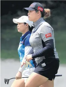  ?? AFP ?? Ariya Jutanugarn, right, and sister Moriya during a recent tournament.