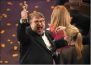  ?? THE ASSOCIATED PRESS ?? Guillermo del Toro, winner of the award for best director for “The Shape of Water,” celebrates in the audience at the Oscars on Sunday at the Dolby Theatre in Los Angeles.