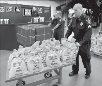  ??  ?? COLORADO RESIDENTS CASH IN: It’s like a modern day Gold Rush. Everyone’s scrambling to get their hands on the heavy, Jumbo Silver Ballistic Bags pictured above before they’re all gone. That’s because residents who find the first 3 digits of their zip code printed in today’s publicatio­n are cashing in on the lowest ever State Minimum price set for the next 2 days by the Federated Mint.