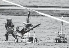  ?? MANUEL BALCE CENETA, AP ?? A member of a bomb squad checks a gyrocopter after a man landed on the West Lawn of the Capitol on Wednesday.