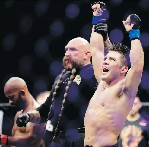  ?? — THE ASSOCIATED PRESS ?? Henry Cejudo celebrates his win against Demetrious Johnson in their flyweight title bout at UFC 227 on Saturday. Also on the card, T.J. Dillashaw took only four minutes to end his rematch with Cody Garbrandt.