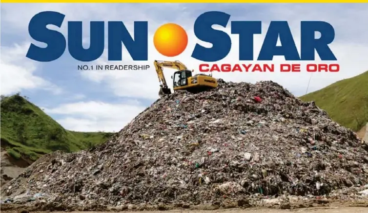  ?? (JOEY P. NACALABAN) ?? MOUNTAIN OF TRASH. A backhoe sits atop a mountain of garbage at the new landfill at Barangay Pagalungan, Cagayan de Oro City. Juices from rotting garbage are reportedly seeping into the Iponan River, a report that is disputed by the City Local...