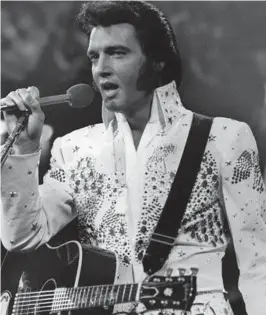  ?? AP ?? Elvis Presley, shown in an undated file photo, wears one of his white jumpsuits during a concert in the later part of his career.