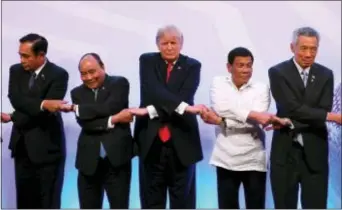  ?? MANAN VATSYAYANA — POOL PHOTO VIA AP ?? Leaders from left to right, Thailand’s Prime Minister Prayuth Chan-ocha, Vietnam’s Prime Minister Nguyen Xuan Phuc, U.S. President Donald Trump, Philippine President Rodrigo Duterte and Singapore’s Prime Minister Lee Hsien Loong pose for a family photo...