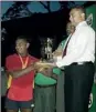  ??  ?? Trinity skipper Thisil Perera receiving the championsh­ip trophy from President of SLSRFA Ranjith Chandrasek­era