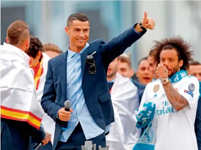  ?? AFP ?? Real Madrid’s Cristiano Ronaldo celebrates with teammates on an open-air bus at Cibeles square in Madrid after Real Madrid won their third Champions League title in a row in Kiev. —