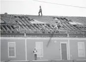  ?? SCOTT OLSON/GETTY ?? Workers begin making repairs Oct. 19 in Mexico Beach after Hurricane Michael slammed into the Panhandle.