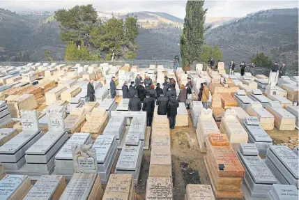  ?? Jack Guez, AFP/Getty Images ?? French Interior Minister Christophe Castaner visits the graves of the victims of the Ozar Hatorah school attack in Toulouse at the Israeli cemetery of Givat Shaul in Jerusalem on Thursday. Israel is hosting world leaders and Holocaust survivors to mark 75 years since the liberation of Auschwitz, the World War II death camp where the Nazis killed more than 1.1 million people, most of them Jews.