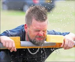  ?? 14752222 ?? Barry Quinn gets sponged in the stocks