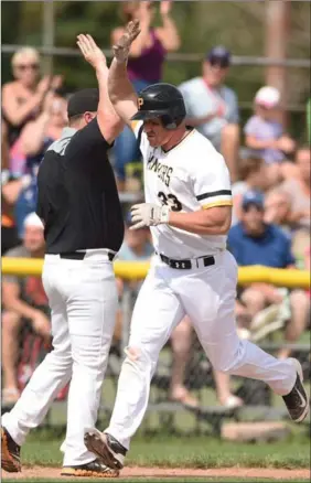  ?? PETER LEE, RECORD STAFF FILE PHOTO ?? Sean Reilly gives a high-five to his third base coach as he rounds the bases, Aug. 6.