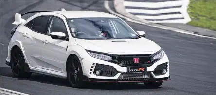  ?? PHOTOS: JOHN COWPLAND/ALPHAPIX ?? Taking flight . . . The Honda Type R comes wrapped up in a massively beefed up and bewinged Civic shell.