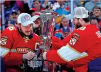  ?? WILFREDO LEE/THE ASSOCIATED PRESS ?? Panthers center Aleksander Barkov, left, and left wing Matthew Tkachuk hold up the Prince of Wales trophy May 24 after the Panthers won Game 4 of the Stanley Cup Eastern Conference Finals against the Carolina Hurricanes in Sunrise, Fla.