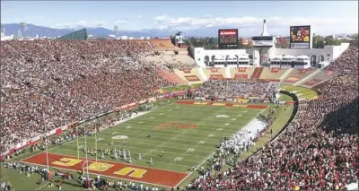  ?? John Antczak/Associated Press ?? The committee bidding to bring the Olympics to Los Angeles in 2024 believes it can keep costs down by using existing buildings, including the LA Coliseum, to host the games.