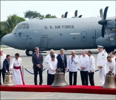  ??  ?? Philippine government officials inspect three church bells seized by American troops as war trophies more than a century ago, as they were returned to the Philippine­s on Tuesday in suburban Pasay city, southeast of Manila, Philippine­s. aP PHoto/BullIt marquez