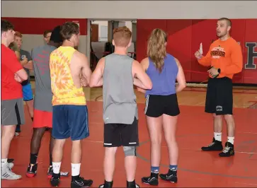  ?? ?? Jeremiah Howe, one of the co-head wrestling coaches at Shelby High School, goes over some things right at THE START OF THE DAY WITH PARTICIPAN­TS IN THE TWO-DAY WRESTLING CAMP. (PHOTO BY CHUCK RIDENOUR)