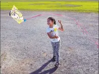  ??  ?? Illianna Antunez, 5, of Sunnyvale, flies her Barbie kite as visitors enjoy the unusually warm weather at Shoreline at Mountain View park on Friday.