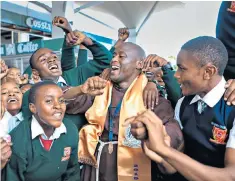  ??  ?? Belief: Peter Tabichi, and below, celebrates winning the $1m prize with students