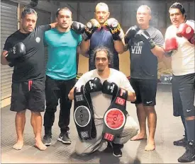 ?? PICTURE / SUPPLIED ?? Fight Nite trainer Jason Reti (standing, centre) with his pugilists — Chase Herbert, Sean Herbert, Rob Leef, Carlos Waikai and in front Rawiri Bishop.