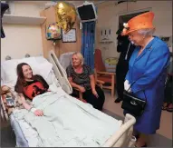  ?? PETER BYRNE/PA WIRE ?? Queen Elizabeth II speaks to Millie Robson, 15, and her mother, Marie, during a visit to the Royal Manchester Children’s Hospital on Thursday to meet victims of the terror attack in the city earlier this week and to thank members of staff who treated...