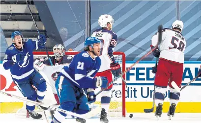  ?? MARK BLINCH GETTY IMAGES ?? Tampa Bay’s Brayden Point, front, scored the winner in the fifth overtime, ending the fourth-longest game in NHL history.