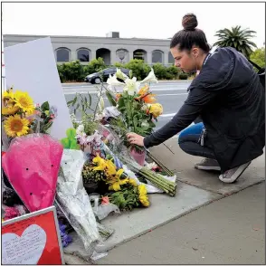  ?? AP/GREG BULL ?? A woman leaves flowers Monday at a makeshift memorial across the street from the Chabad of Poway synagogue in Poway, Calif.