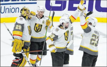  ??  ?? Golden Knights members Marc-andre Fleury, from left, Reilly Smith, Alex Tuch and Alec Martinez celebrate their 4-0 win over the Minnesota Wild on Saturday.