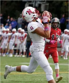  ?? MARy SchwALm PhOtOS / bOStON heRALd ?? HARD TO CONTAIN: Natick’s Jake Adelmann (5) breaks free from a tackle attempt from Wellesley’s Jacob Parker (9). Right, Jayson Little hauls in a touchdown pass during the first quarter of the Redhawks’ 42-21 win Saturday.