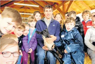  ??  ?? Baa- rilliant fun Pupils from Dalmelling­ton Primary School learned how to feed lambs.