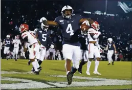  ?? AP PHOTO — BARRY REEGER, FILE ?? Penn State running back Journey Brown (4) celebrates his third quarter touchdown run against Rutgers during an NCAA college football game in State College, Pa. Big Ten is going to give fall football a shot after all.
