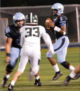  ?? DEBBY HIGH/FOR DIGITAL FIRST MEDIA ?? North Penn’s QB Solomon Robinson looks for an open receiver on Friday night against Ridley.