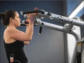  ?? TAMMY LJUNGBLAD / KANSAS CITY STAR ?? Katie Prue, 30, an employee at Cerner Corp.’s Innovation­s Campus in Kansas City, works out over her lunch hour at a fitness center on campus. “I feel more energized after a workout,” she said.