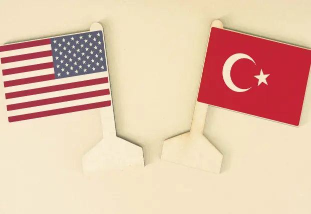  ??  ?? The flags of Turkey and the U.S. made of recycled paper are displayed on a cardboard desk.