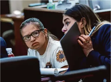  ?? Sam Owens/ Staff photograph­er ?? Miranda Casarez, 25, listens as legal assistants review evidence during her trial Tuesday morning. She has been charged with injury to a child causing serious bodily injury by omission in the starvation death of her stepson, Benjamin Cervera, 4, in August 2021.