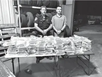  ?? Submitted photo ?? Police stand with drugs confiscate­d during a traffic stop.