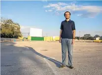  ??  ?? Chip Sawyer, owner of the Silver Moon Drive-In, stands in front of one of the screens as the sun sets.