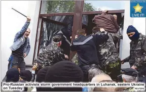  ??  ?? Pro-Russian activists storm government headquarte­rs in Luhansk, eastern Ukraine on Tuesday.
REUTERS