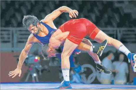  ?? REUTERS ?? India’s Bajrang Punia (in blue) in action against Haji Aliyev of Azerbaijan in the men’s 65kg freestyle semi-final at the Makuhari Messe Hall on Friday.